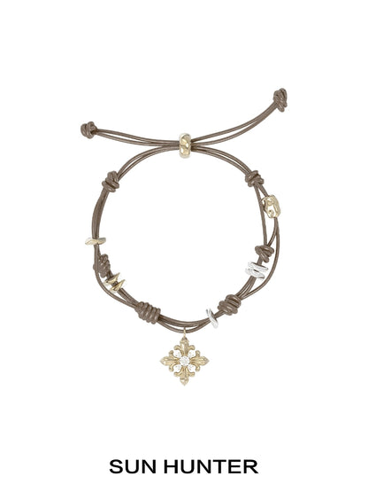 SUN HUNTER Twilight Iris braided bracelet with decorative charms and adjustable closure