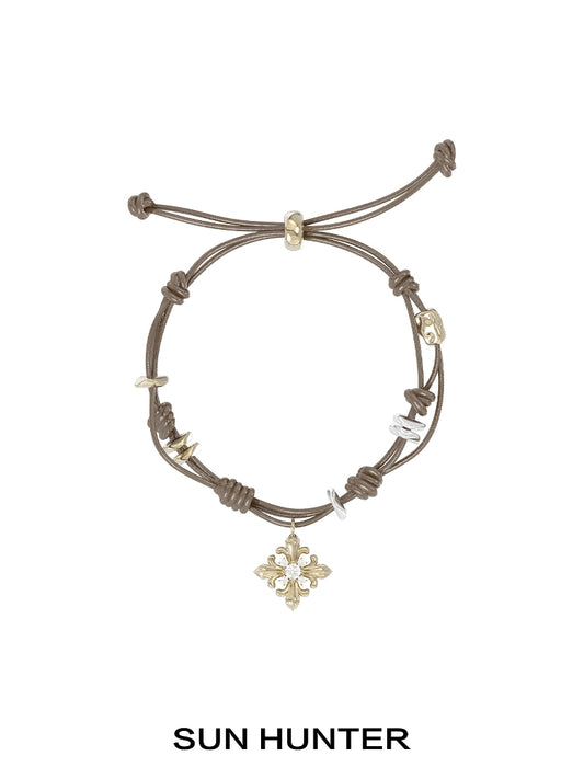 SUN HUNTER Twilight Iris braided bracelet with decorative charms and adjustable closure
