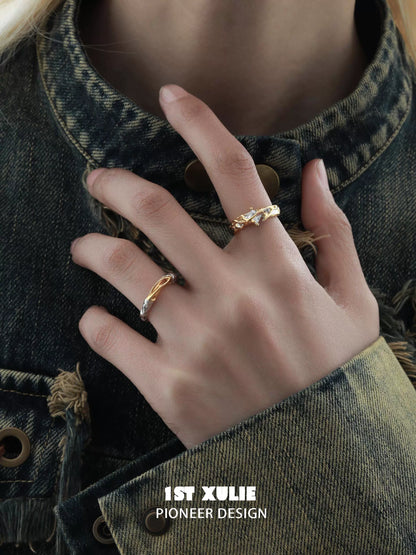 Elegant hand model displaying unique couple rings in gold with intricate designs