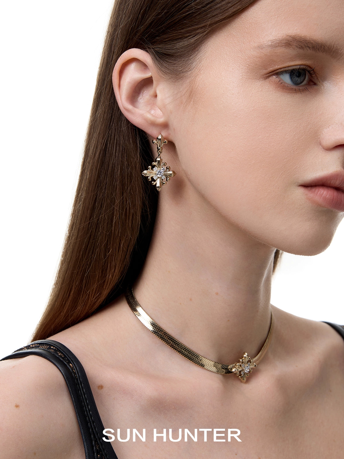 Elegant model showcasing unique floral drop earrings from SUN HUNTER, perfect for any occasion.