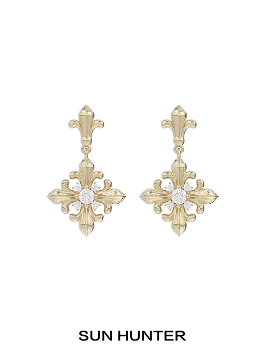 Unique floral drop earrings by SUN HUNTER featuring an elegant gold design with a sparkling center stone