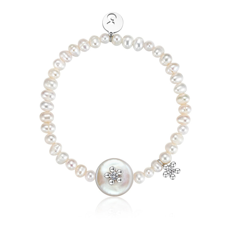 SUN HUNTER unique pearl bracelet featuring a charming floral charm and a large central pearl