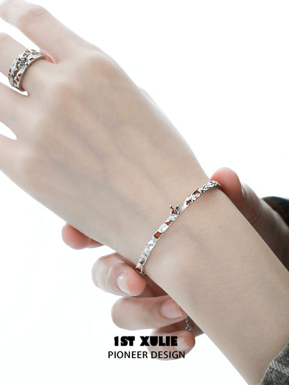 Stylish unique silver bracelet for women featuring a sleek design and sparkling accents.