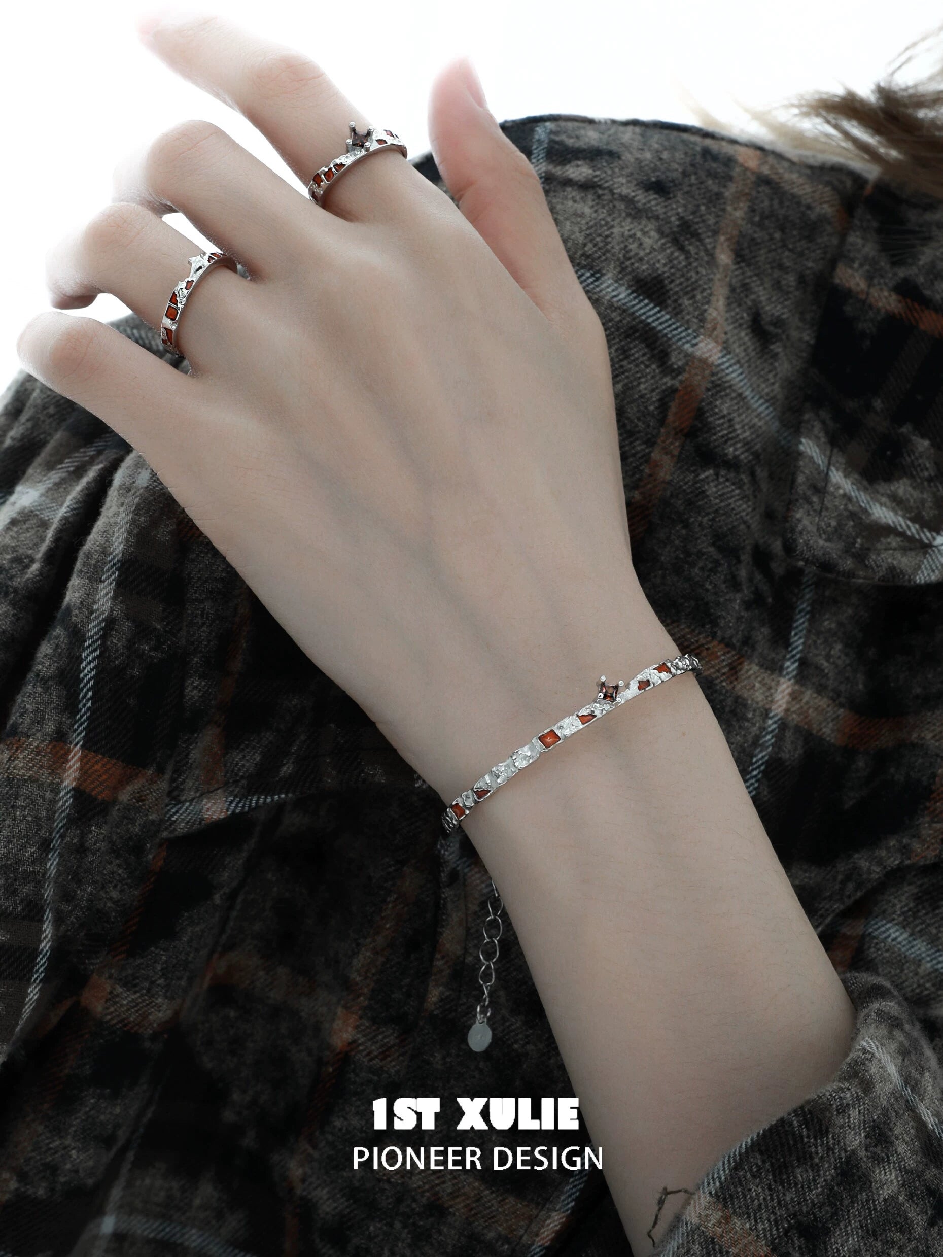 Elegant unique silver bracelet for women showcased on a hand with stylish rings, perfect for any occasion