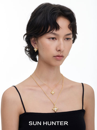 Model wearing unique square stud earrings by SUN HUNTER paired with a matching necklace