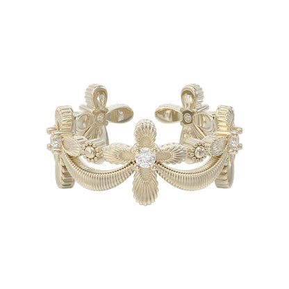 Elegant SUN HUNTER shimmer cross ring featuring intricate floral designs and sparkling accents