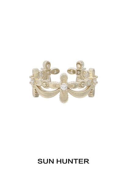 Elegant SUN HUNTER shimmer cross ring featuring intricate detailing and a sparkling center stone