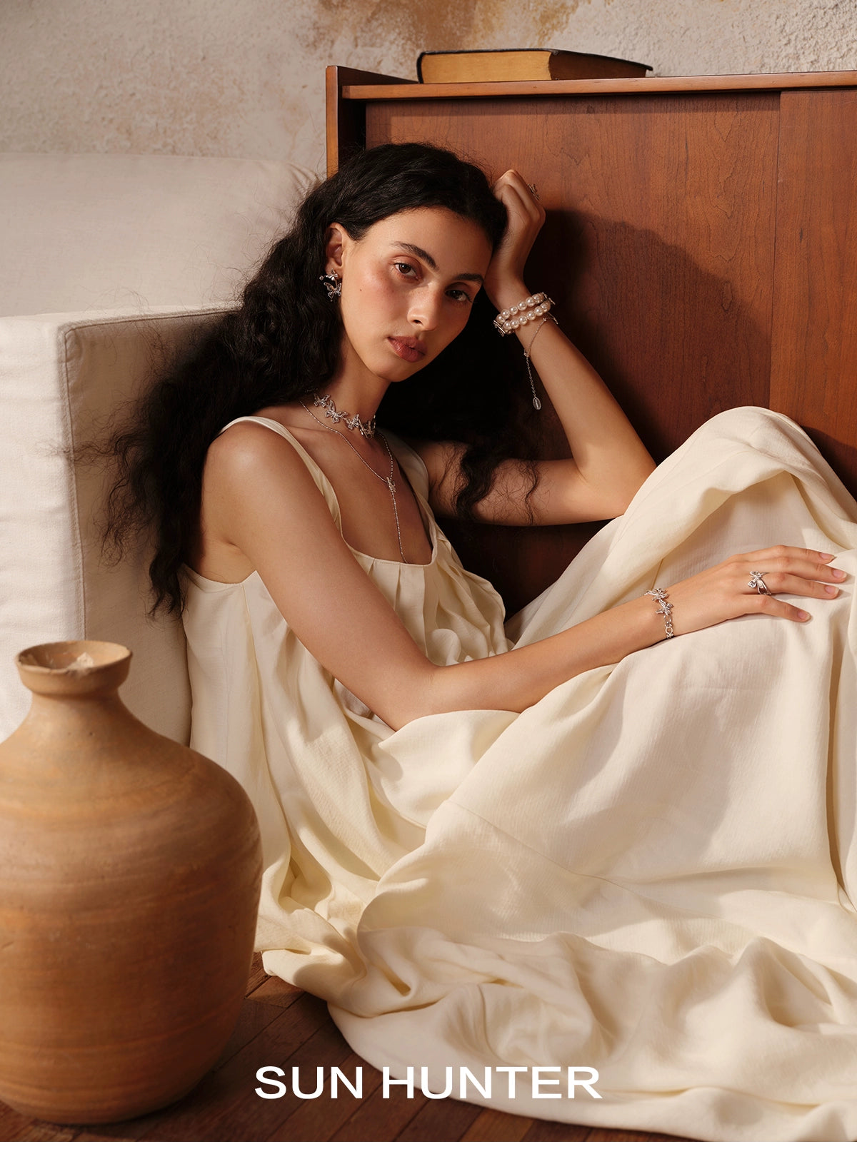 Elegant model wearing vintage butterfly earrings, showcasing a soft and chic style with fine jewelry