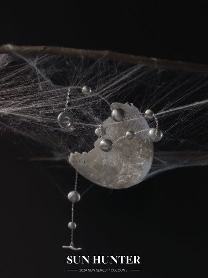 Unique vintage cocoon earrings with delicate design featuring silver accents and a modern aesthetic