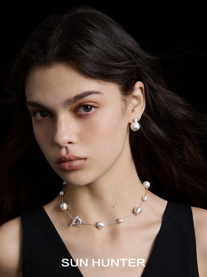 Model wearing SUN HUNTER vintage cocoon earrings paired with a chic necklace