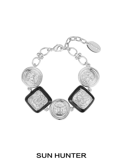 SUN HUNTER vintage coin bracelet with silver and black design featuring unique coin charms
