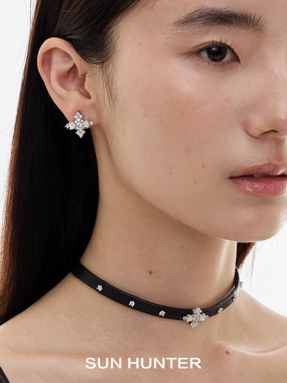 Model wearing SUN HUNTER vintage cross earrings, adorned with sparkling stones for a chic look