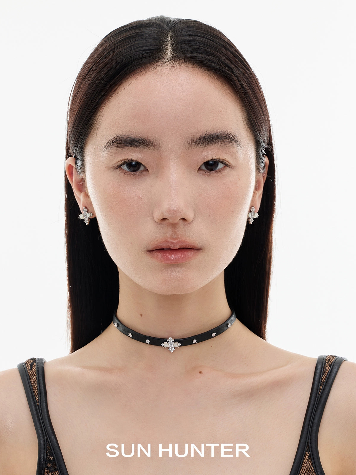 Stylish model wearing vintage cross earrings with a chic choker necklace from SUN HUNTER