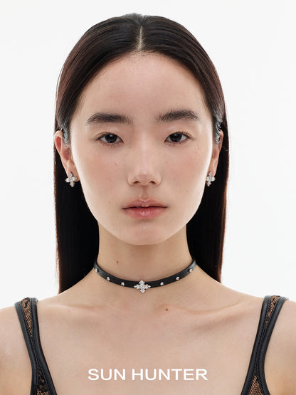 Stylish model wearing vintage cross earrings with a chic choker necklace from SUN HUNTER