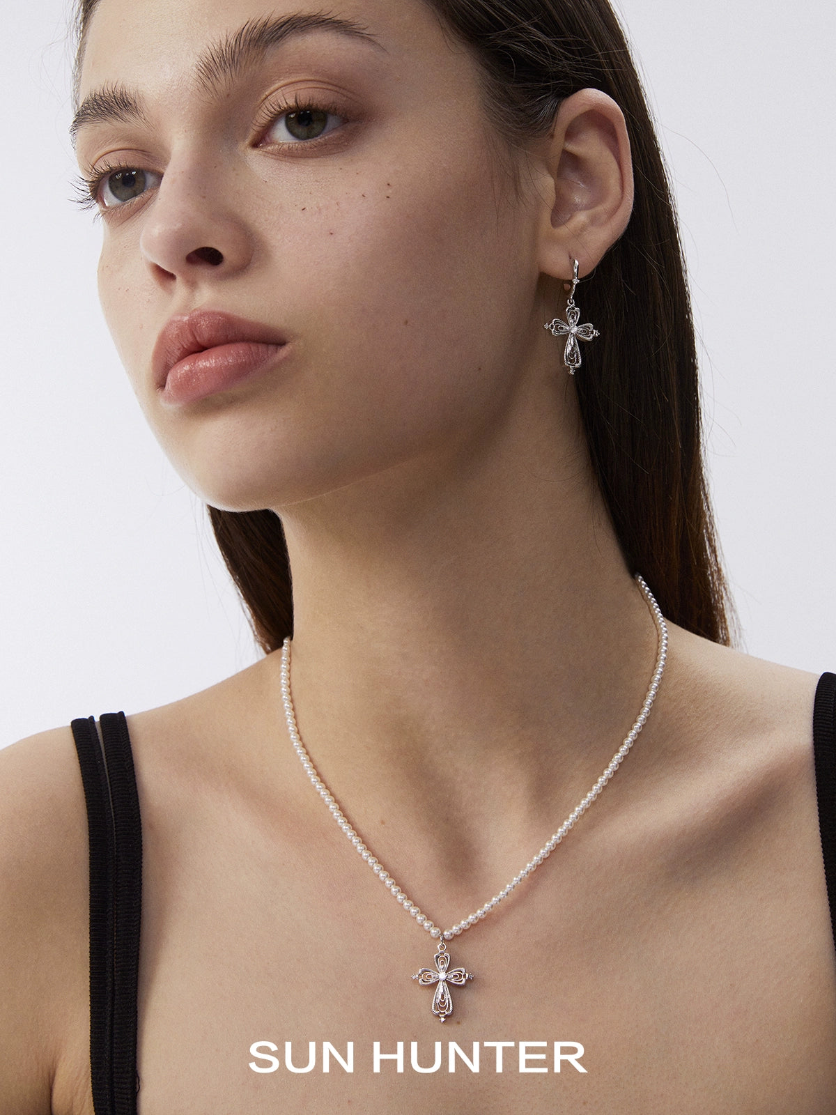Elegant SUN HUNTER vintage cross pearl necklace paired with matching earrings for a timeless look