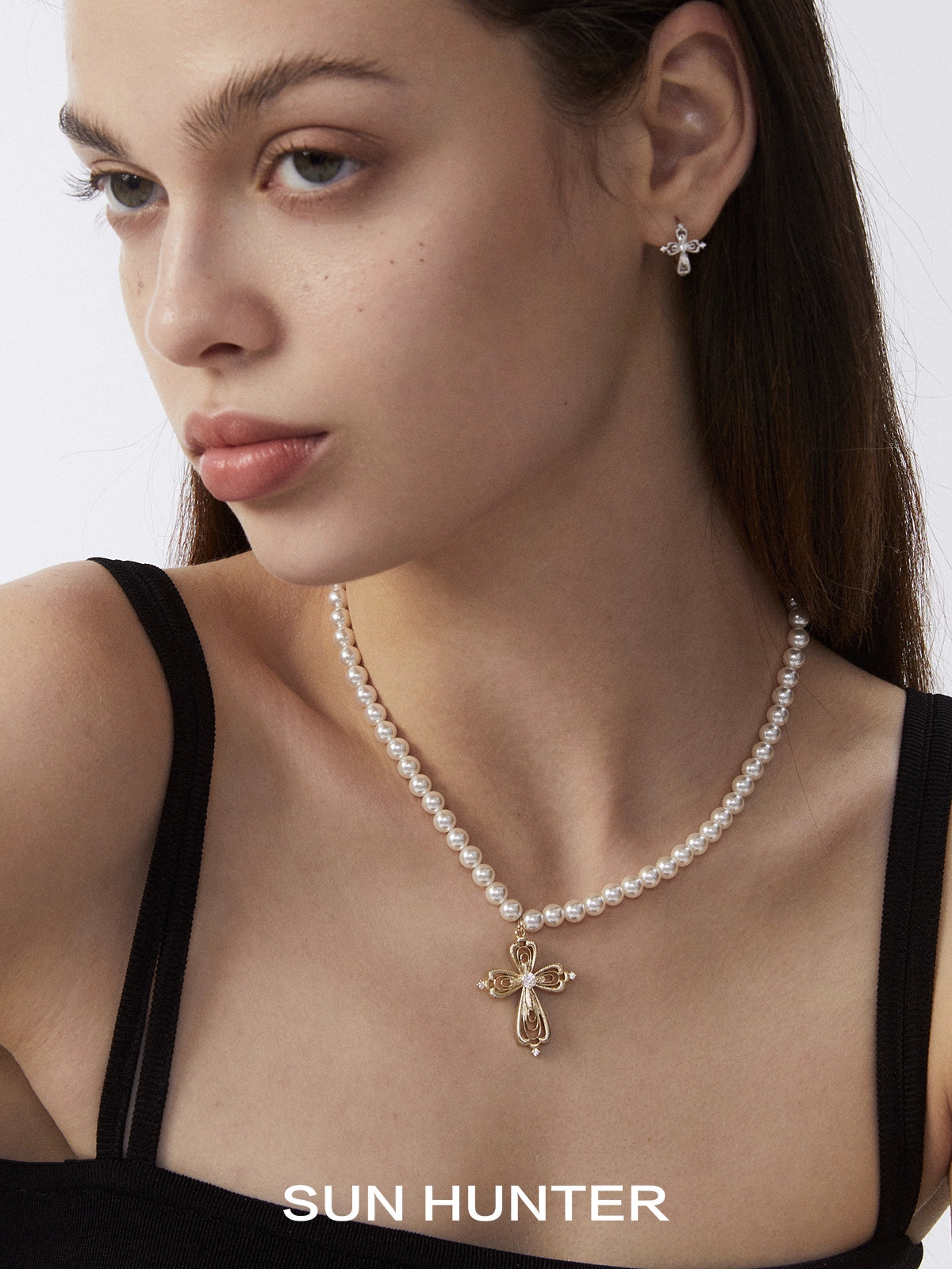 Elegant vintage cross pearl necklace with a delicate gold cross centerpiece by SUN HUNTER