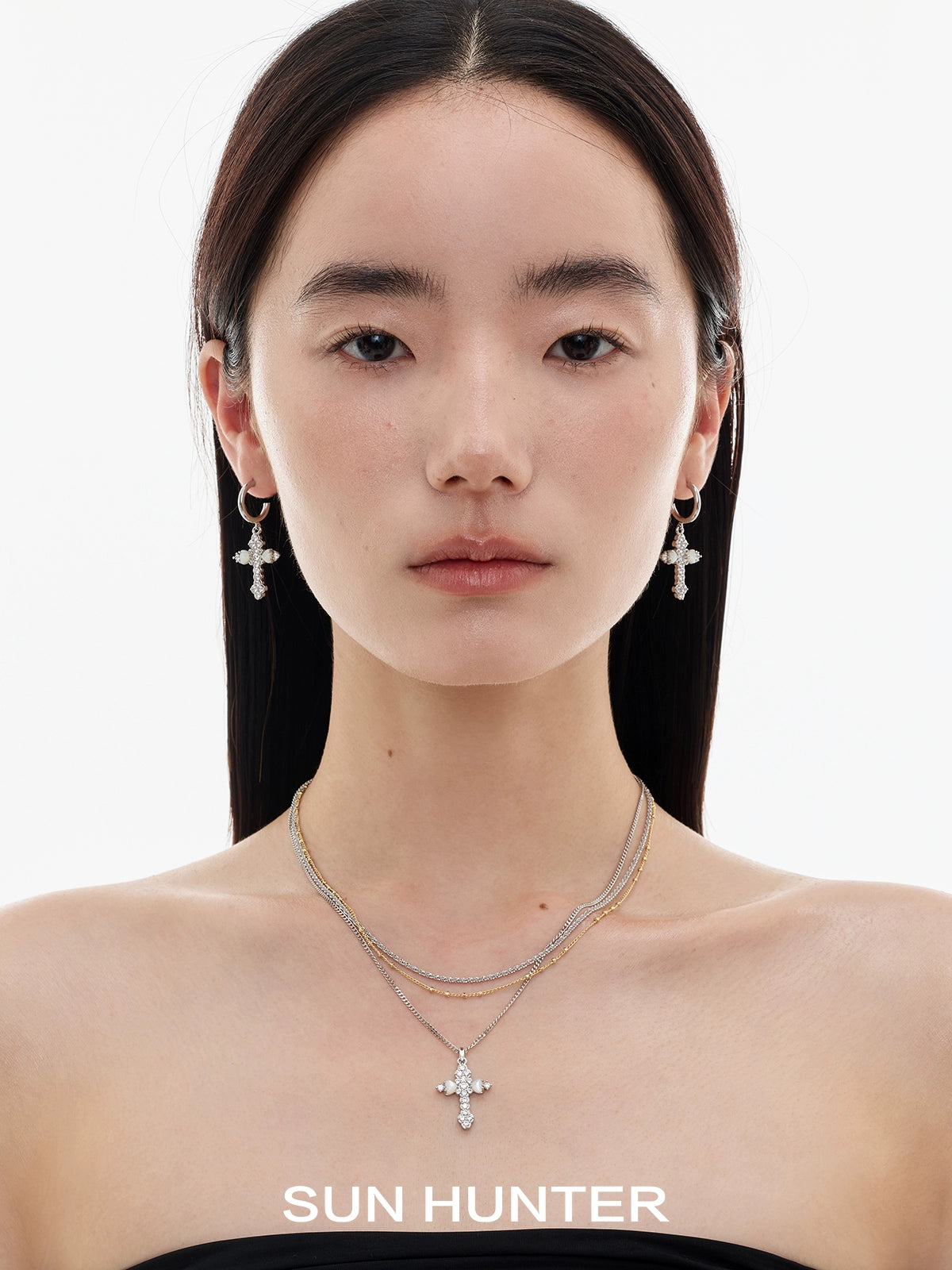 Model wearing vintage cross zircon earrings by SUN HUNTER for a stylish look