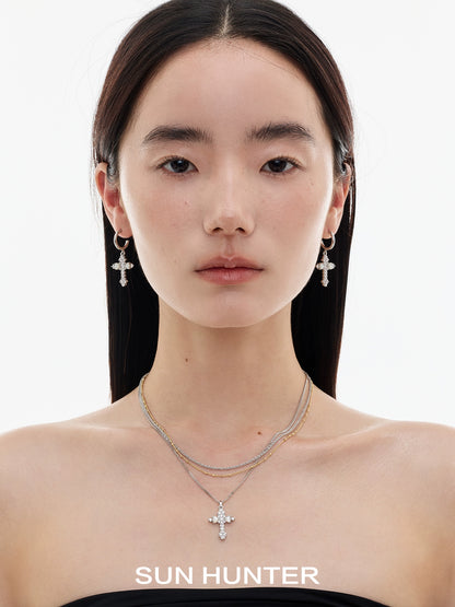 Model wearing vintage cross zircon earrings by SUN HUNTER for a stylish look