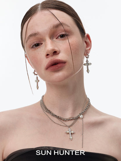 Model wearing SUN HUNTER vintage cross zircon earrings showcasing a elegant design with sparkling stones