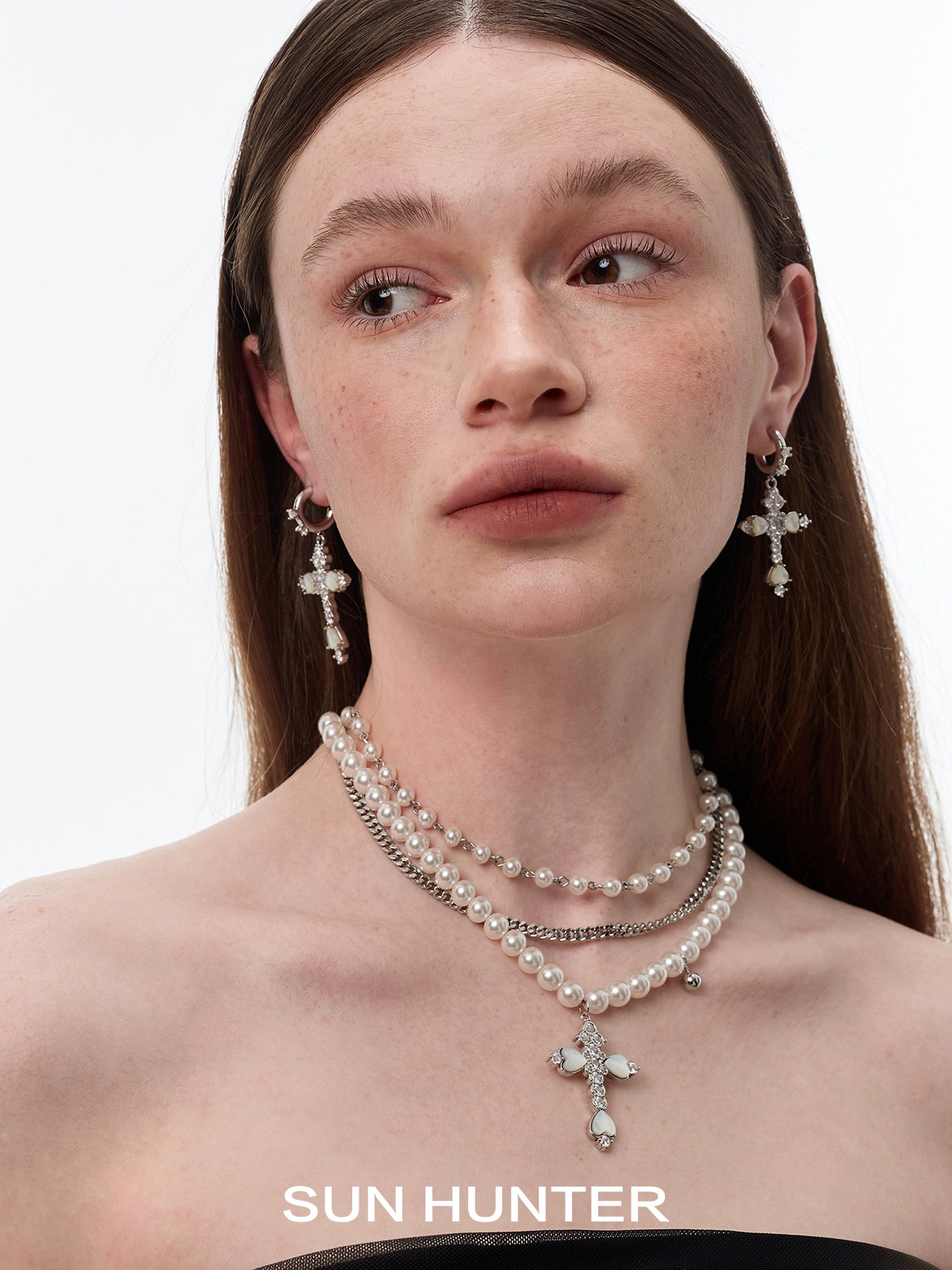 Elegant SUN HUNTER vintage cross zircon earrings with intricate design and shimmering details