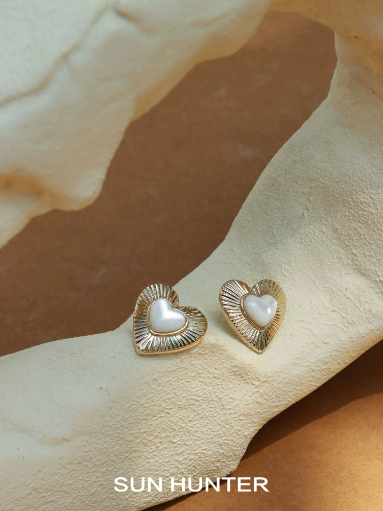 SUN HUNTER vintage heart stud earrings with a pearl center and textured metal design