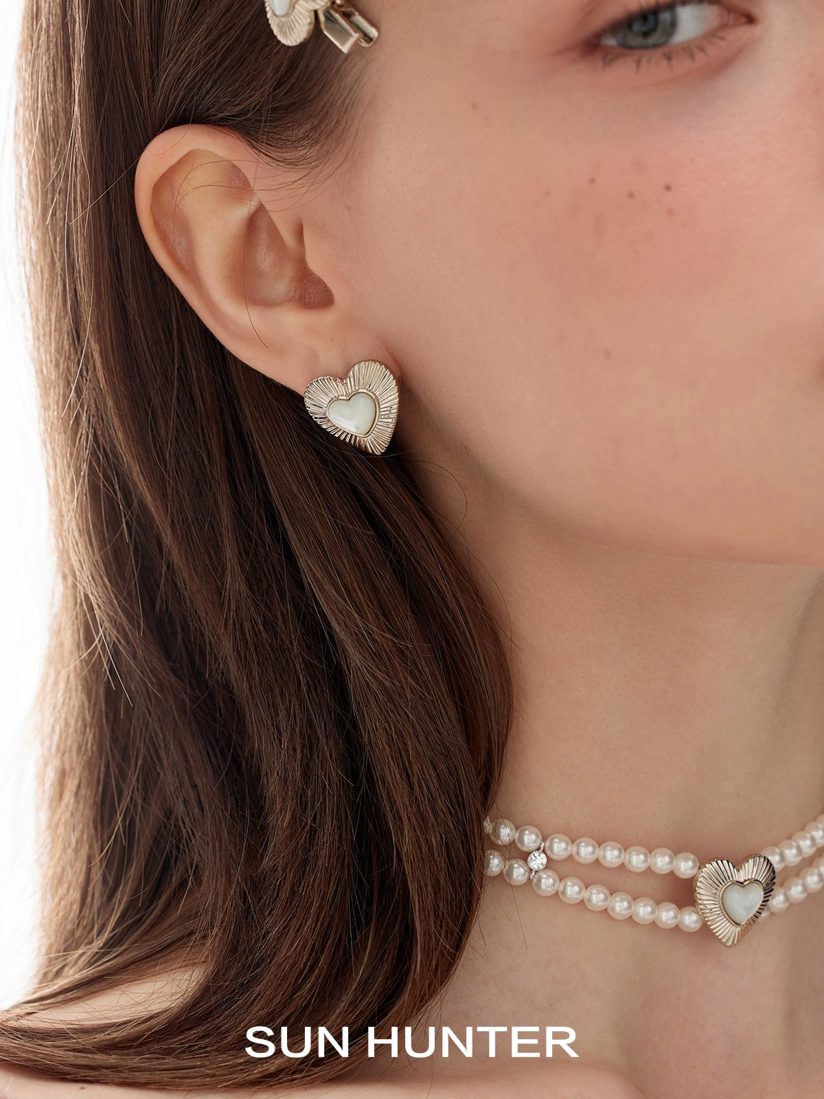 Vintage heart stud earrings by SUN HUNTER with a shiny, elegant design for a classic look