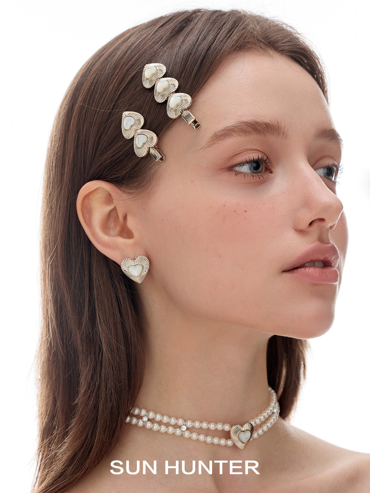 SUN HUNTER vintage heart stud earrings showcased on model with matching accessories