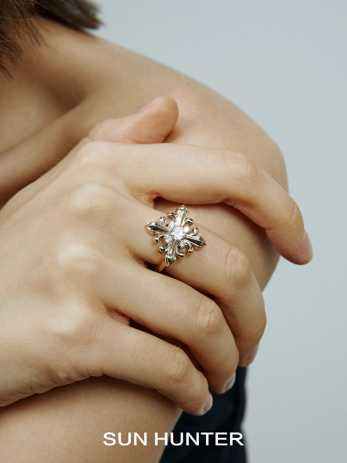 Elegant vintage iris square ring by SUN HUNTER showcasing intricate floral design set on a hand model