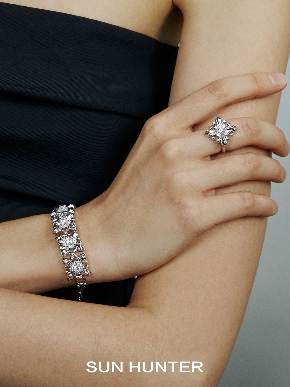 Elegant SUN HUNTER vintage iris square ring displayed on model's hand with matching bracelet