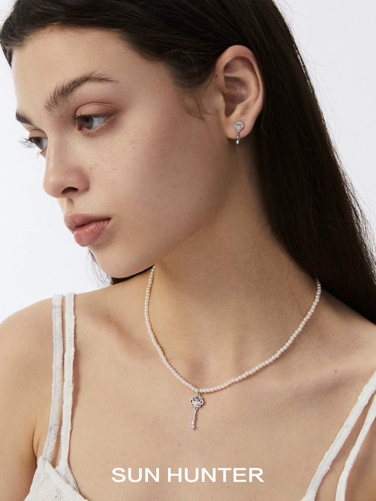 Elegant model wearing SUN HUNTER vintage lace key earrings with a matching necklace for a vintage look
