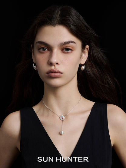 Model wearing SUN HUNTER vintage orbital earrings paired with a matching necklace in elegant styling