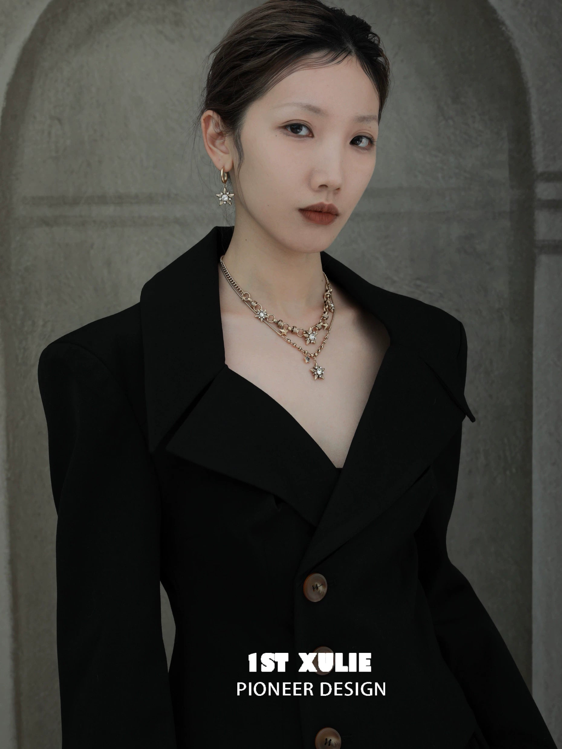 Model wearing a vintage starlight pendant necklace paired with a stylish black blazer