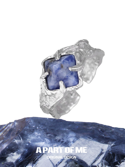 A unique silver ring featuring a vibrant violet gemstone ring with a textured design