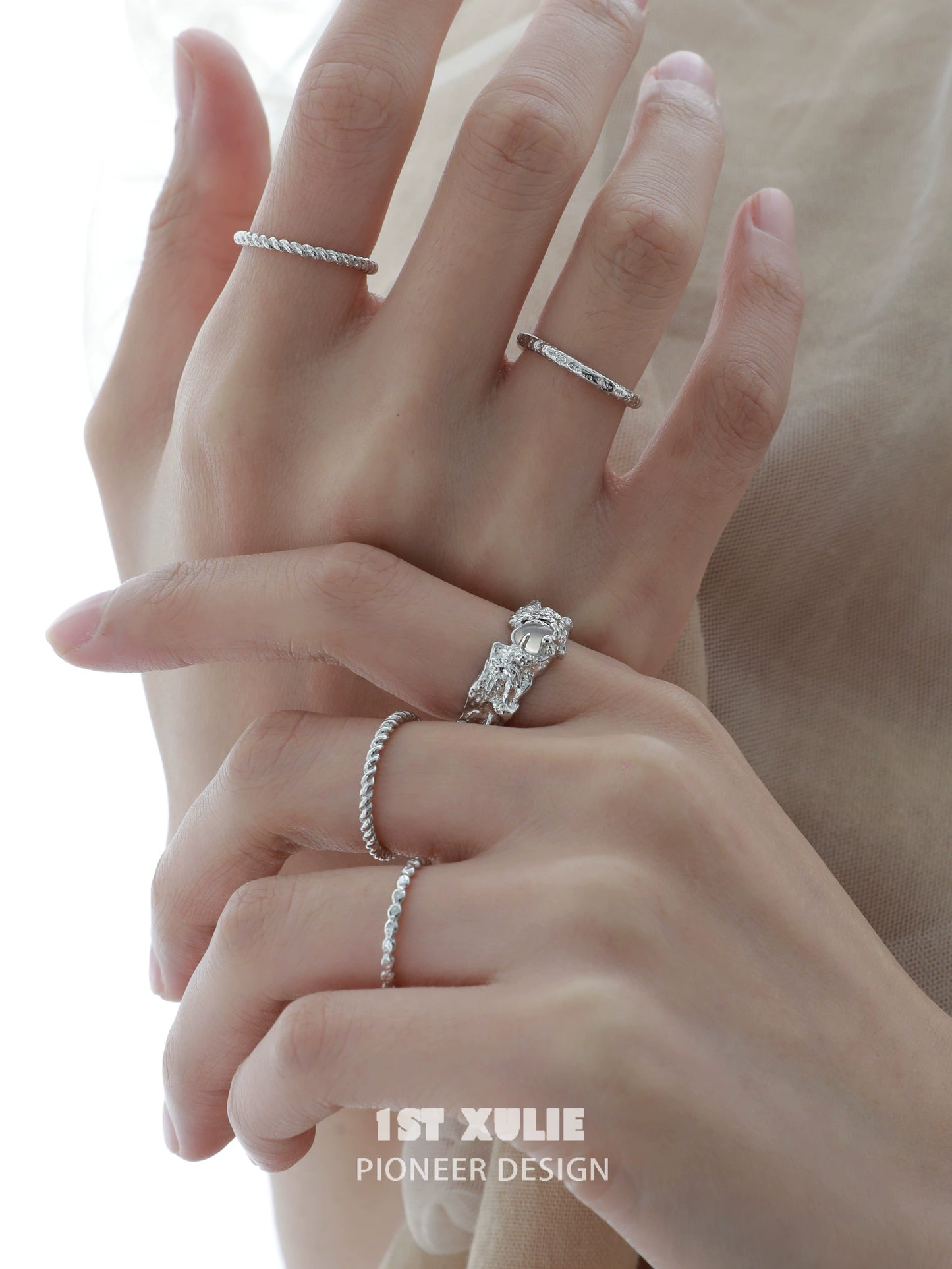 Elegant white agate ring showcased alongside other delicate silver rings on a hand