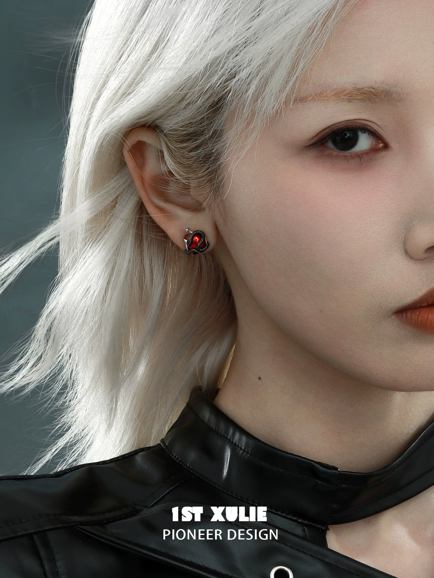 Wicked apple snake ear studs by 1STXULIE featuring intricate design and vibrant colors