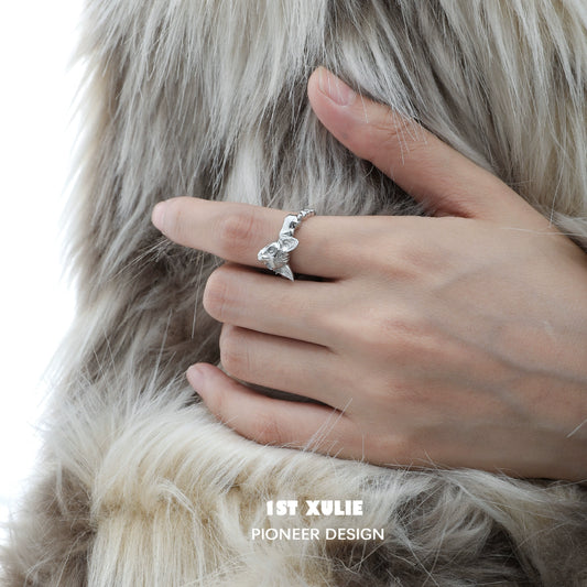 Y2K cat silver ring showcased on a model's hand with soft fur background