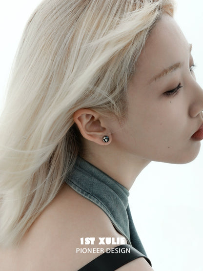Y2K black silver stud earrings showcased on a model with sleek blonde hair