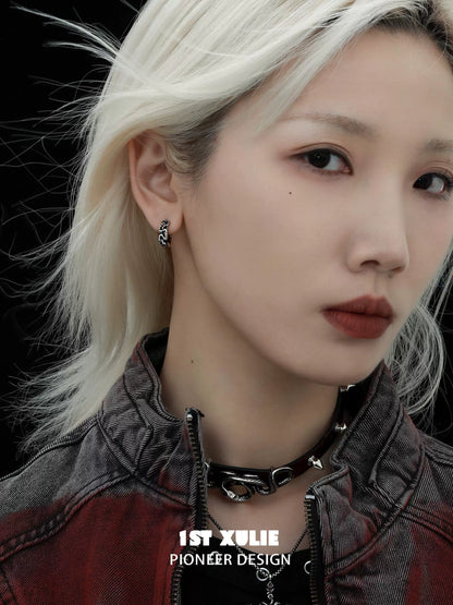 Y2K black snake earrings dangling from a model's ear, adding a trendy touch to her edgy style