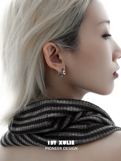 Y2K butterfly earrings showcased on model with short hair, paired with a stylish striped scarf