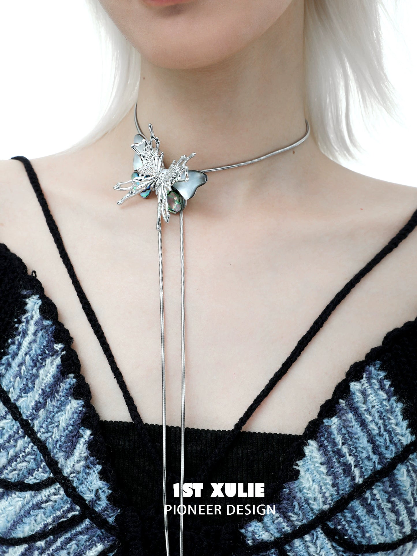 Y2K butterfly necklace with silver accents and a unique design worn on a model