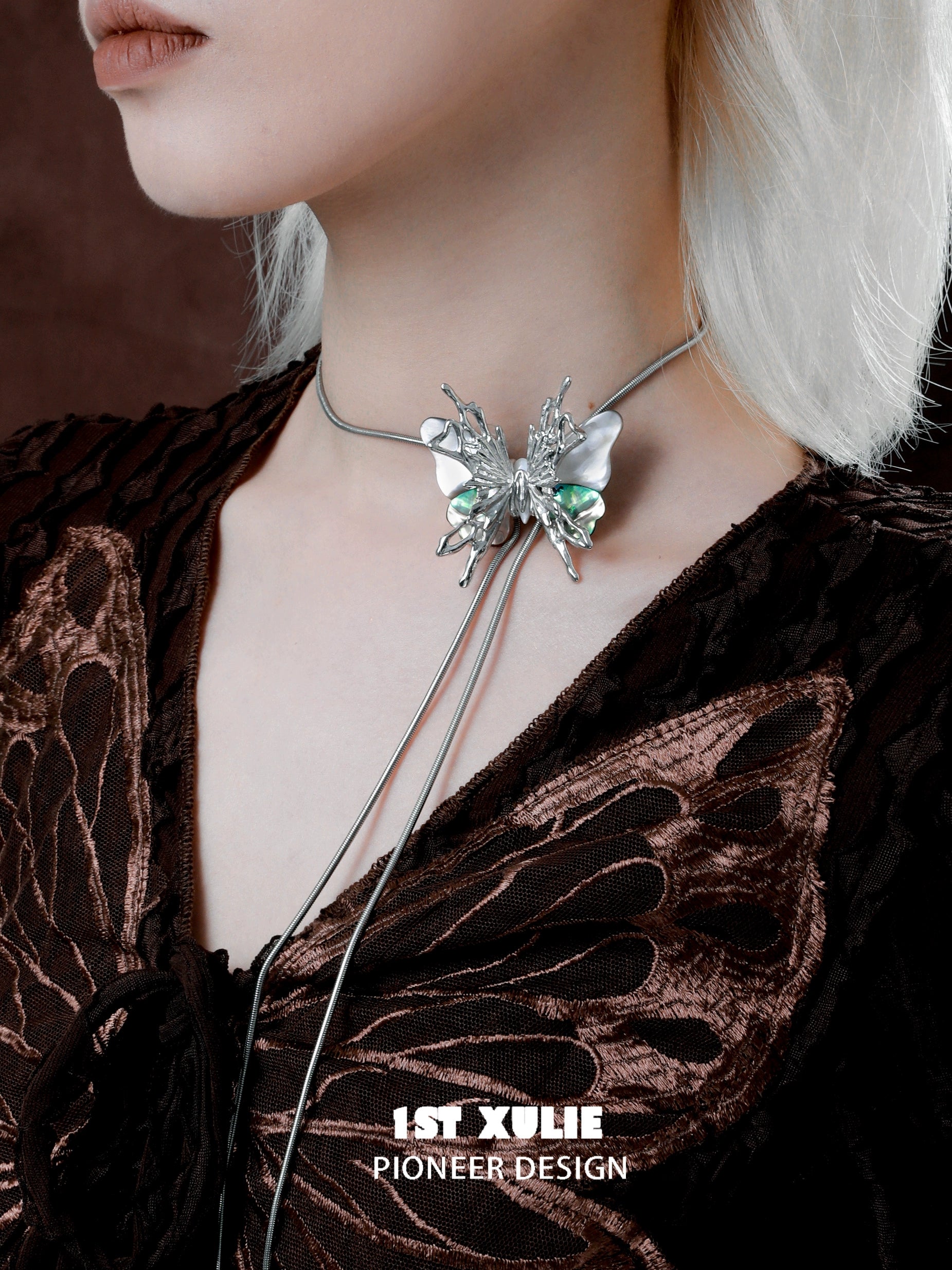 Y2K butterfly necklace with silver and green detailing worn on a model's neck