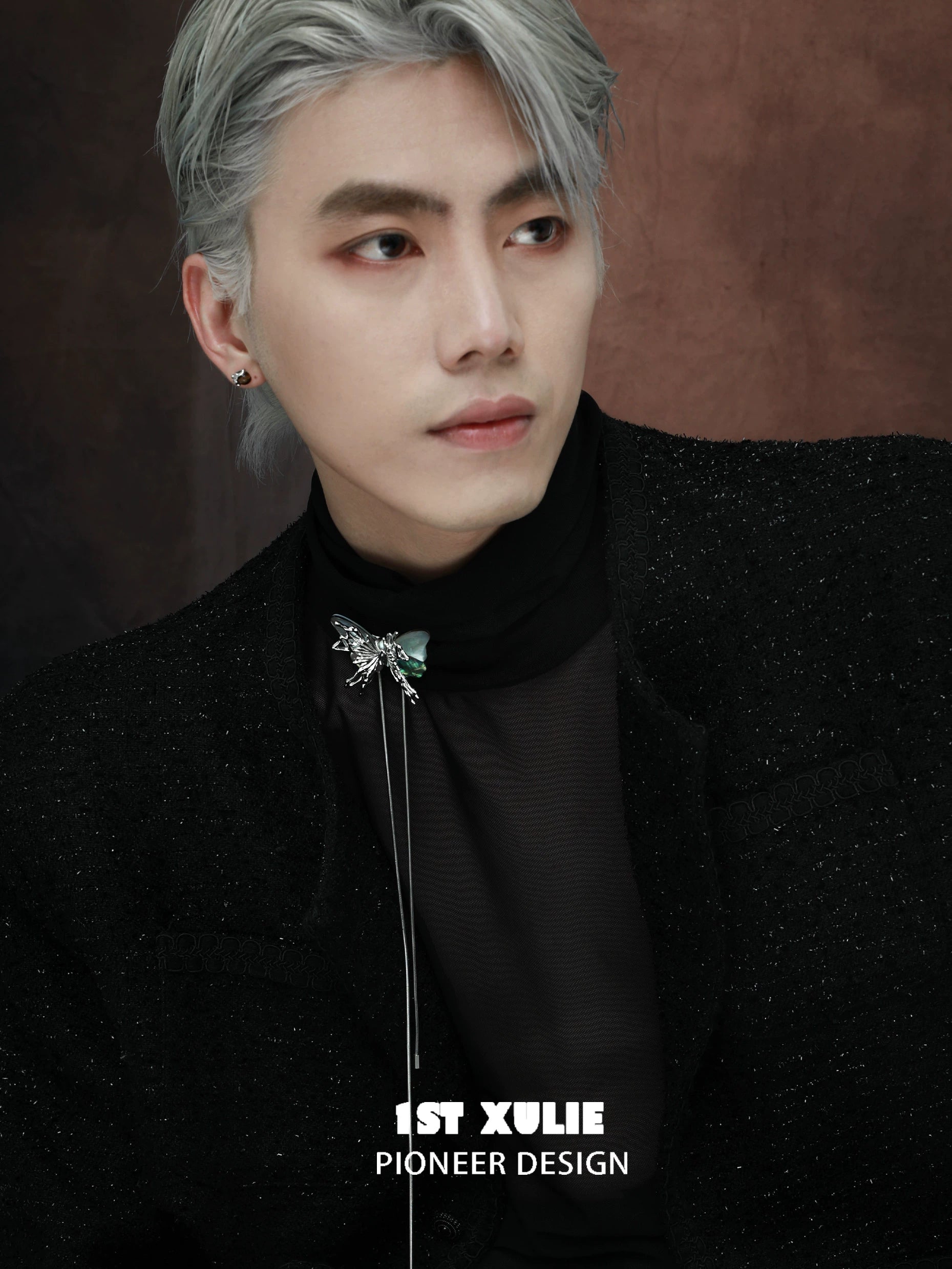 Y2K butterfly necklace styled on model with silver hair and sleek fashion ensemble