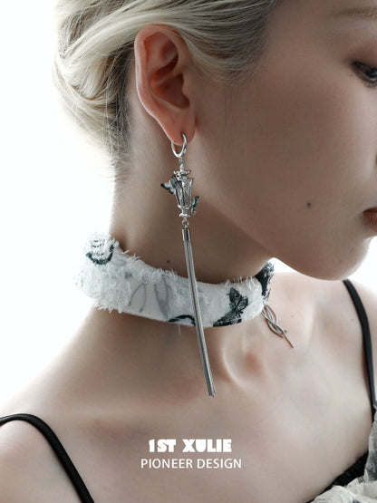Y2K butterfly tassel earrings in silver, stylish design worn by a model with a choker