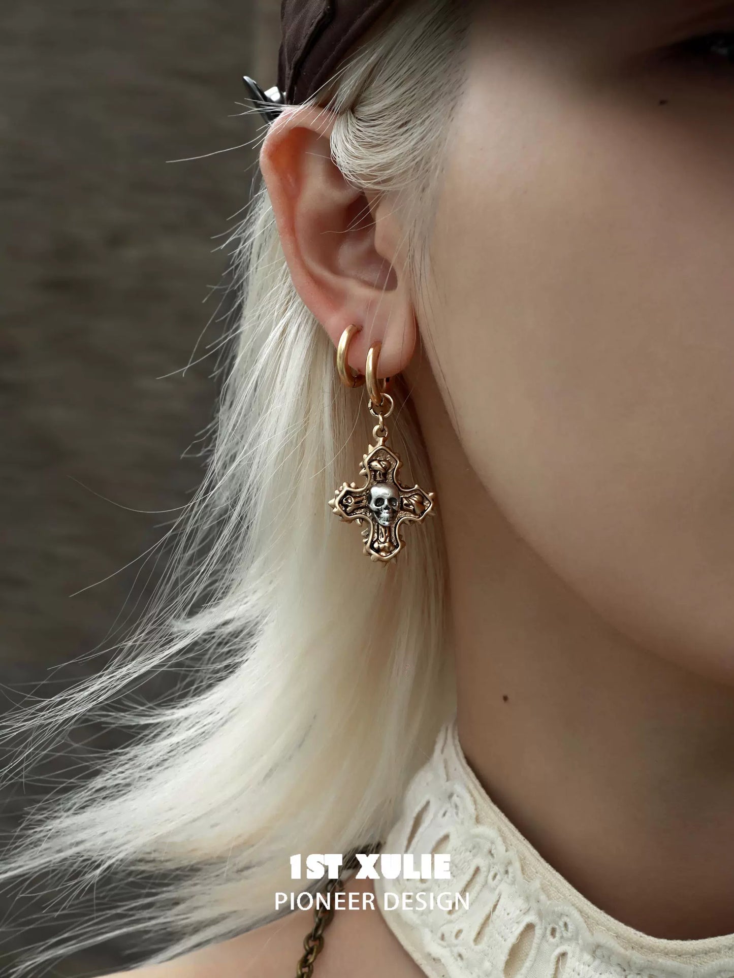 Y2K cross earrings with skull detail, adding a unique and edgy touch to any outfit