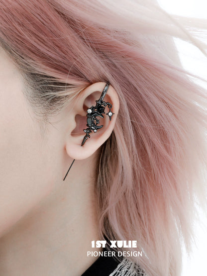 Y2K dark moon ear piercing with intricate design featuring stars and flowers