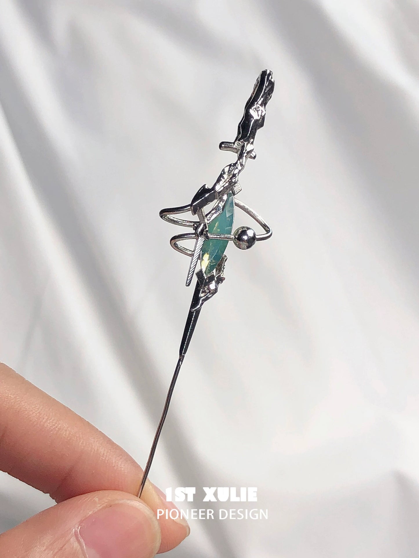 Y2K dream core ear piercing needle featuring a unique design with a green gem and metallic finish