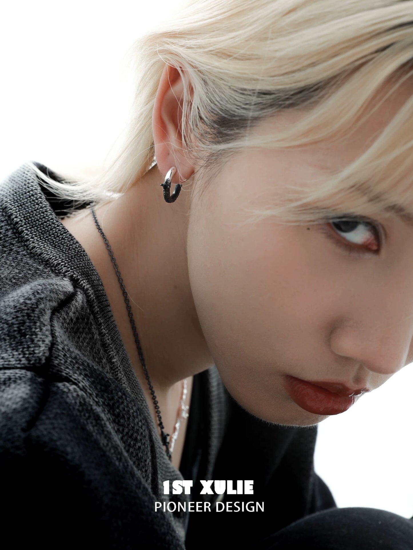 Y2K fire earrings featuring a unique design worn by a model with blonde hair
