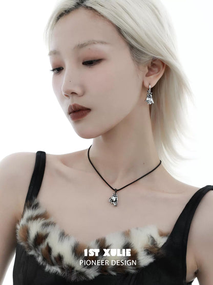 Y2K ghost black cat earrings worn by a model with a stylish hairstyle and a chic outfit