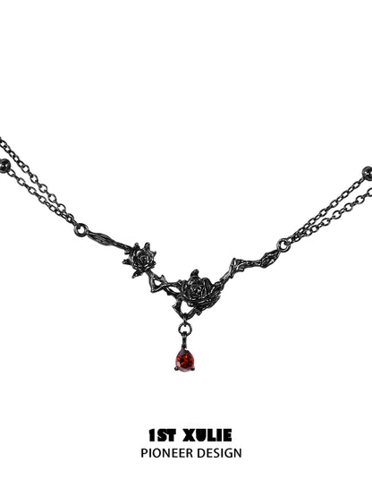 Y2K goth rose necklace with intricate black roses and a red gemstone pendant
