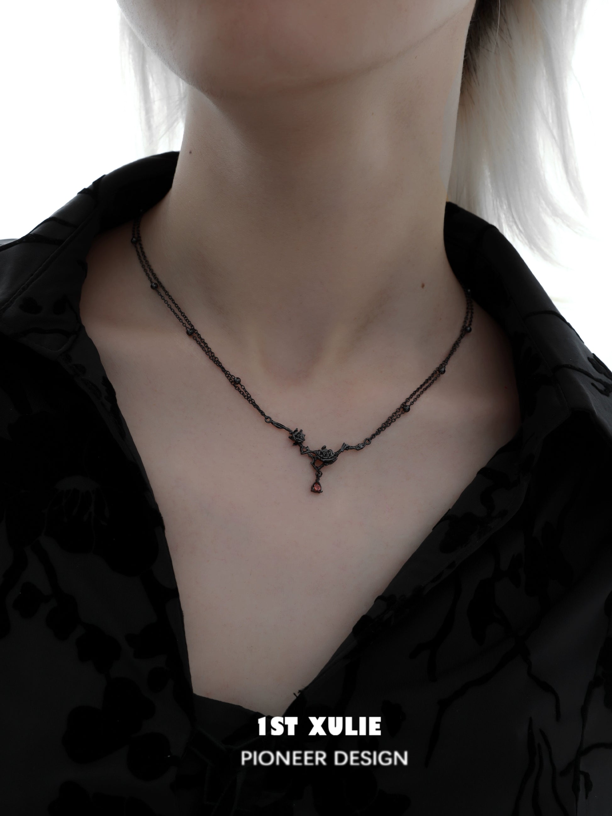Y2K goth rose necklace from 1STXULIE featuring a dark design on a model's neck